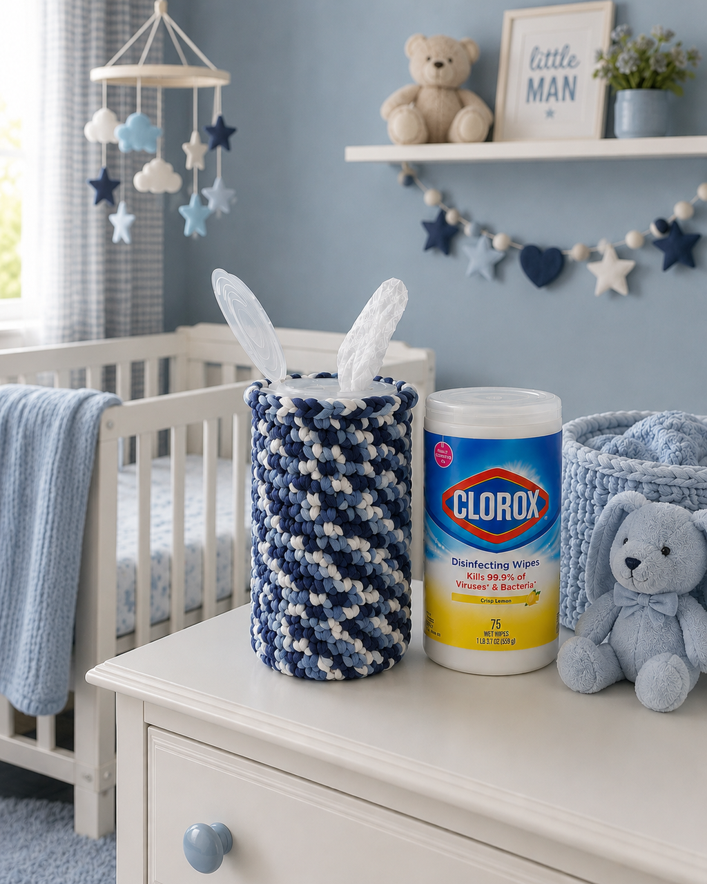 Blue and white crochet disinfecting wipes cover displayed in a baby nursery